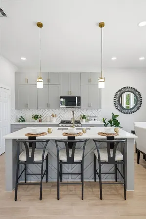 a kitchen with a dining table and chairs