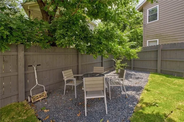 a view of a chairs and table in backyard