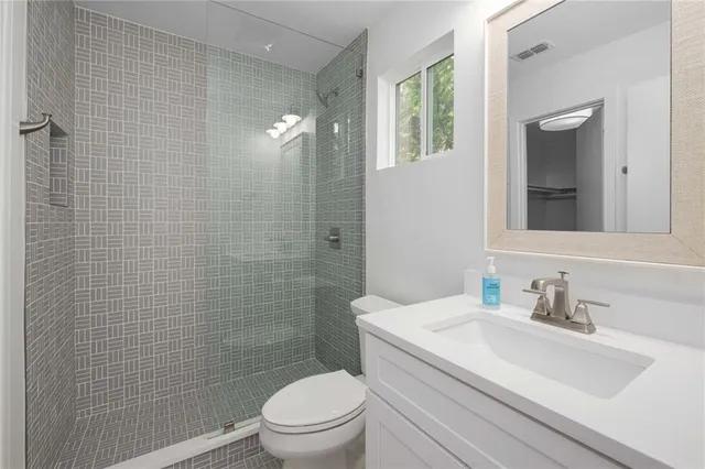 a bathroom with a sink toilet and shower