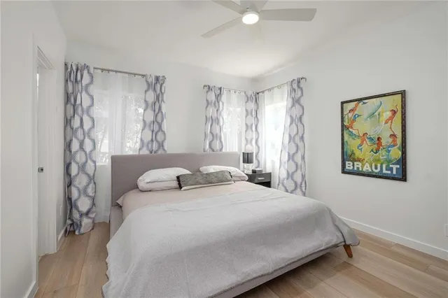 a bedroom with a bed and a painting on the wall