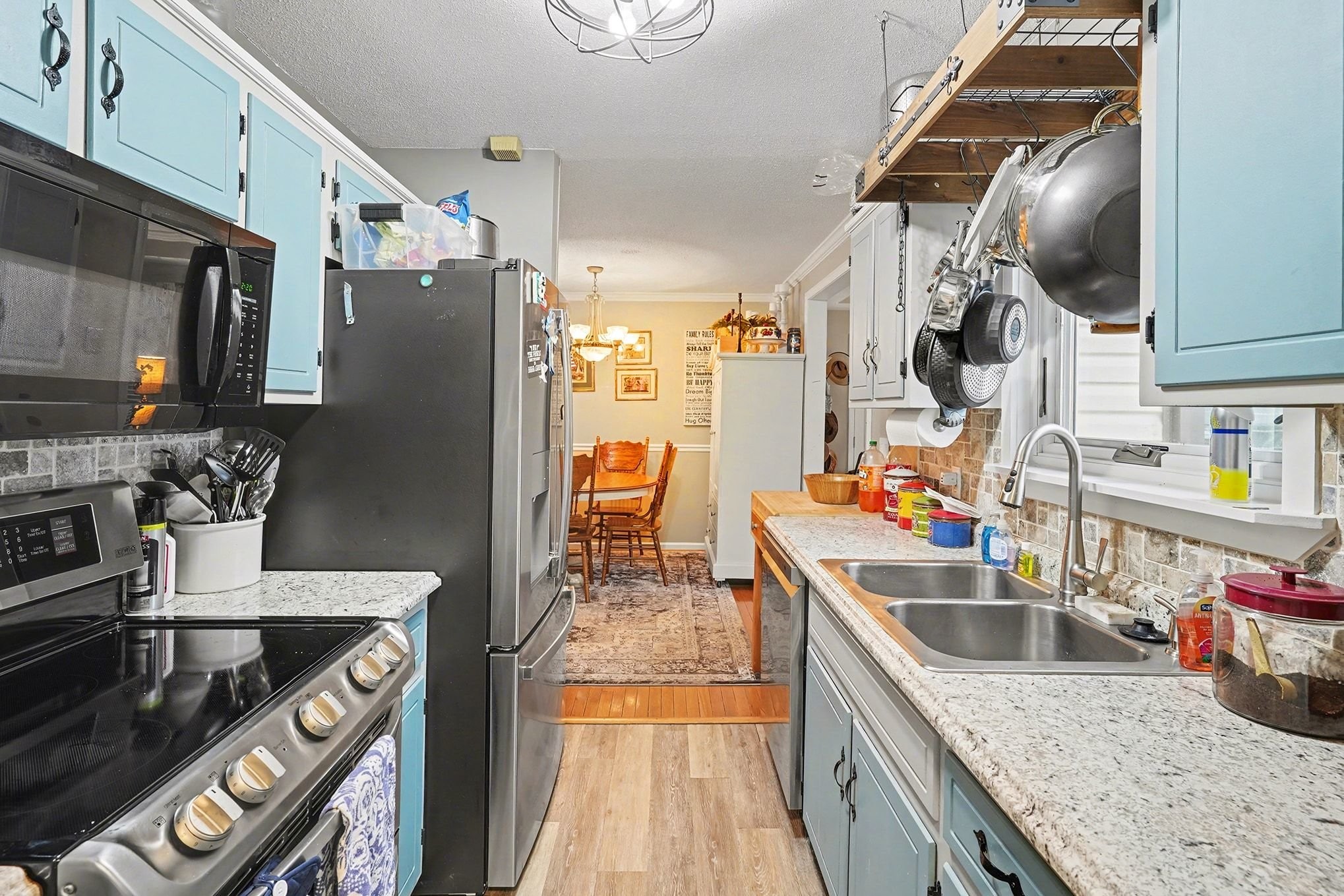 4918 Woodrow Road Woodlawn, TN 37191 - Photo 11 of 28 a kitchen with stainless steel appliances granite countertop a sink stove and refrigerator