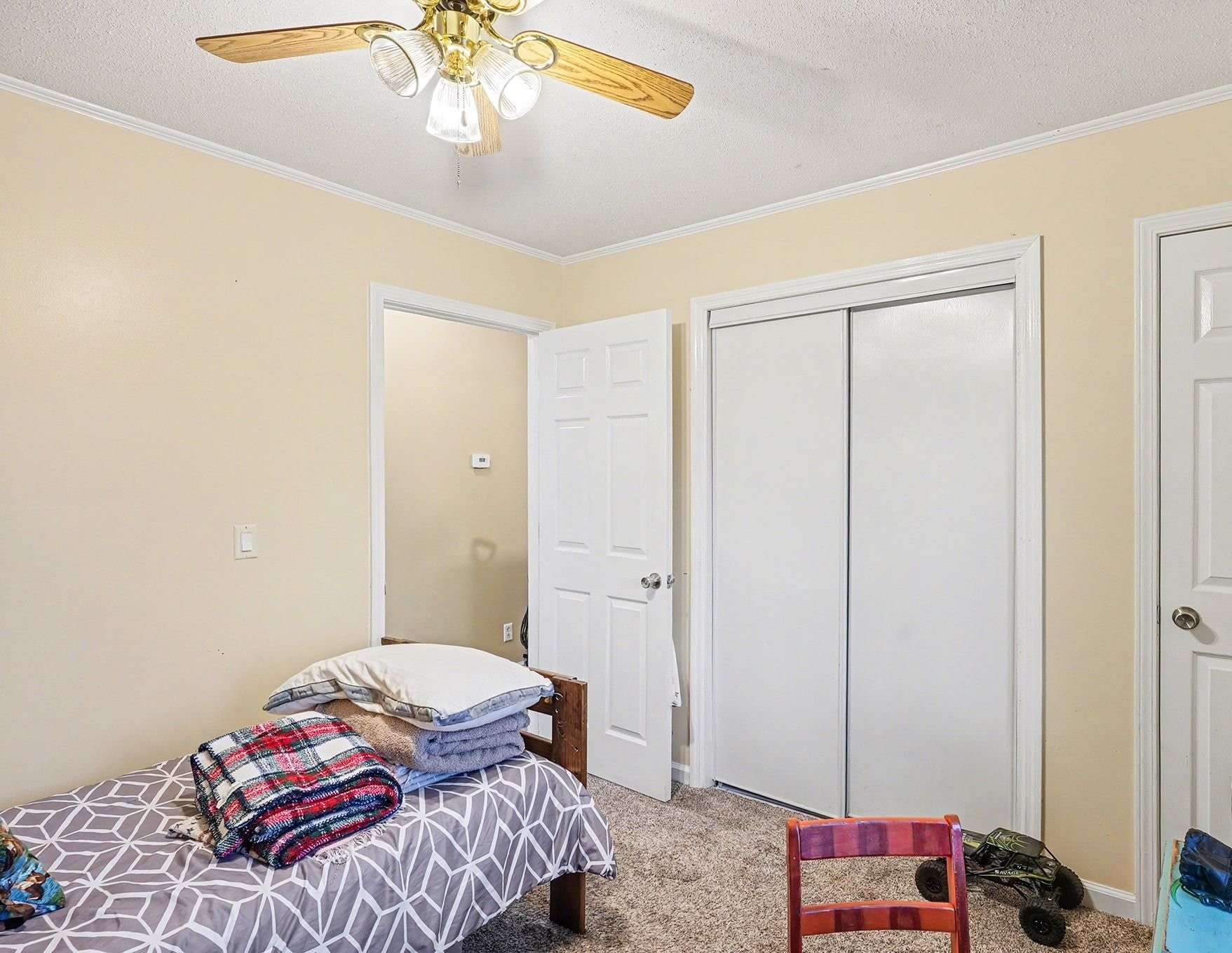4918 Woodrow Road Woodlawn, TN 37191 - Photo 18 of 28 a bedroom with a bed and a chandelier