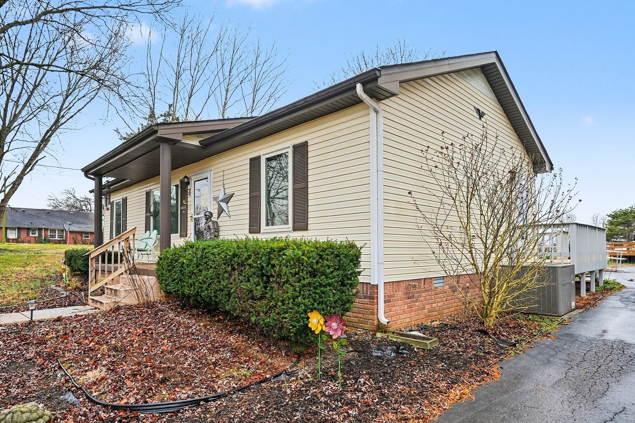 4918 Woodrow Road Woodlawn, TN 37191 - Photo 2 of 28 a front view of a house with garden