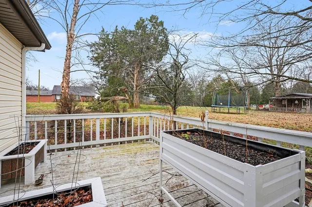 a view of a roof deck with wooden floor and fence