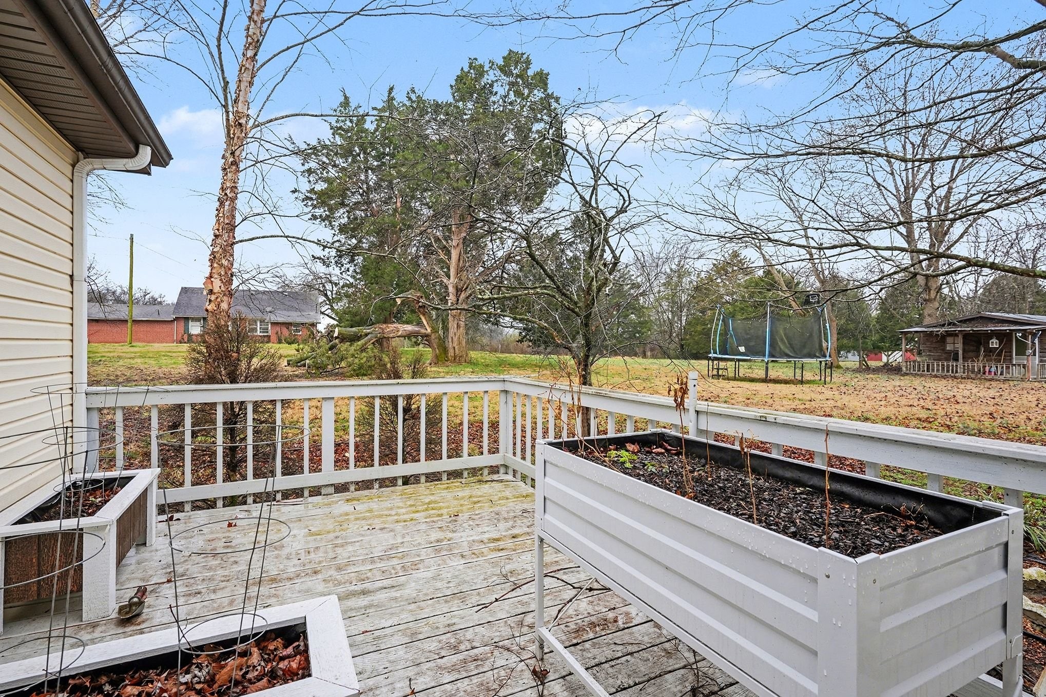 4918 Woodrow Road Woodlawn, TN 37191 - Photo 23 of 28 a view of a roof deck with wooden floor and fence