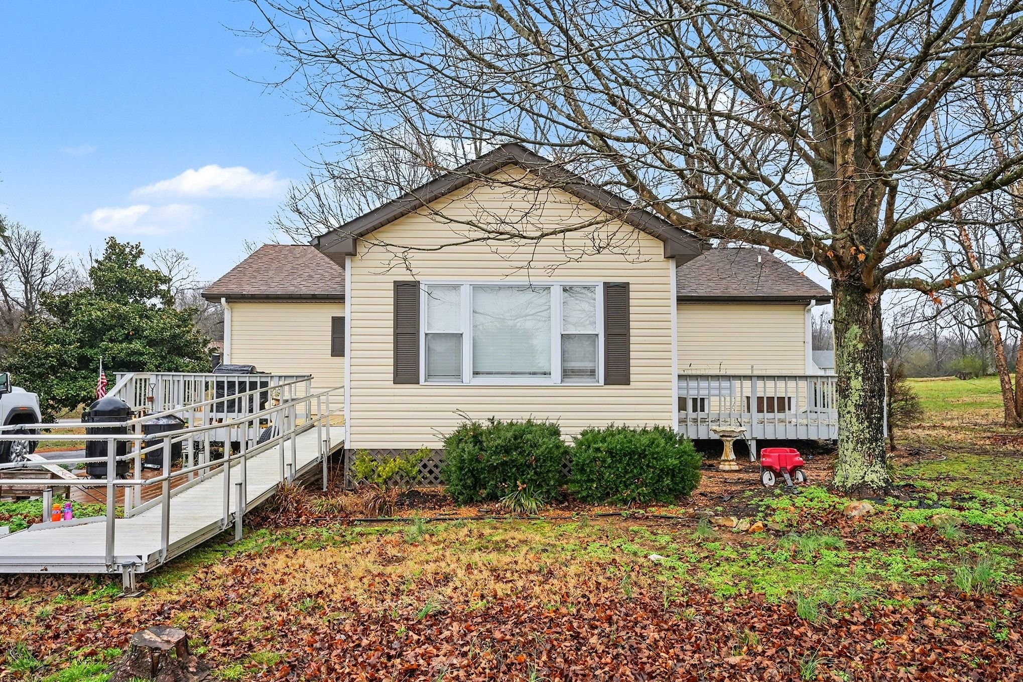 4918 Woodrow Road Woodlawn, TN 37191 - Photo 24 of 28 a front view of house with sign board and yard