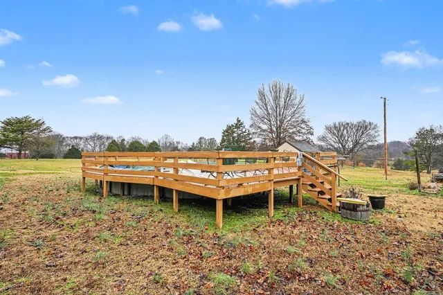 a backyard of a house with wooden floor and outdoor seating