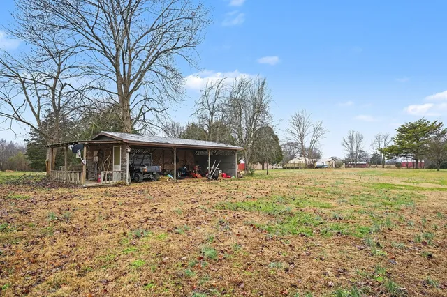 a front view of house with yard and trees