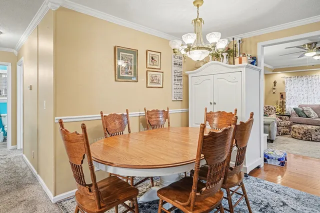 a view of a dining room with furniture and chandelier
