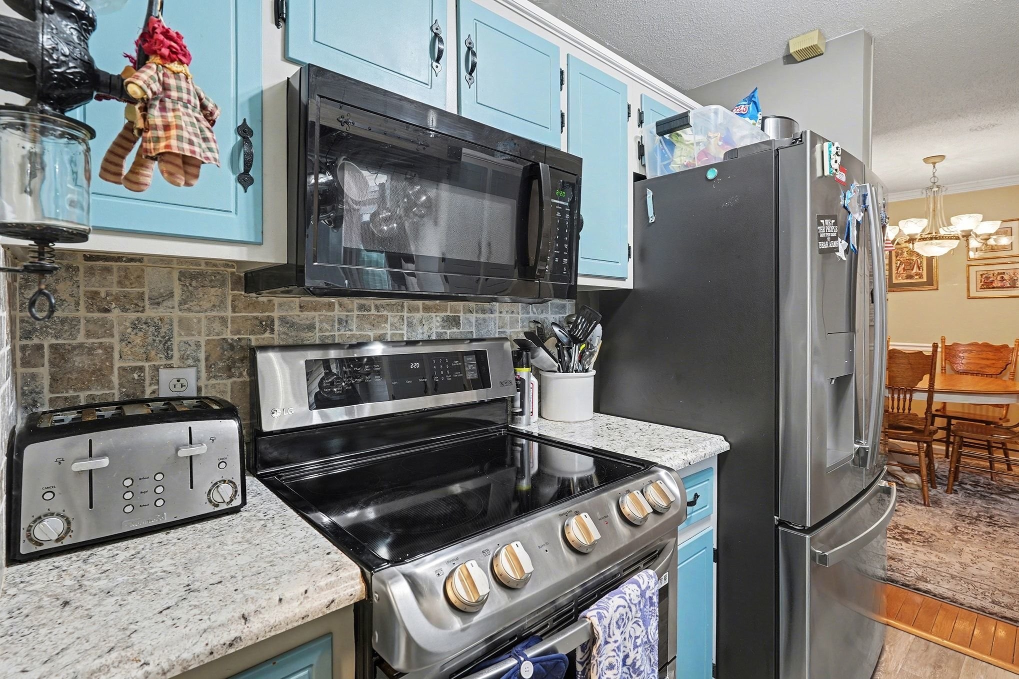 4918 Woodrow Road Woodlawn, TN 37191 - Photo 10 of 28 a kitchen with stainless steel appliances granite countertop a stove and a refrigerator