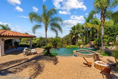a swimming pool with outdoor seating yard and barbeque oven
