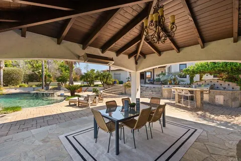 an aerial view of residential house with an outdoor space and seating area