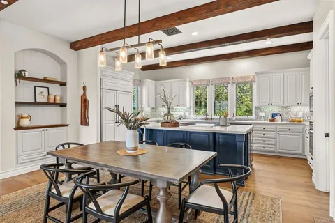 a kitchen with a table and chairs in it