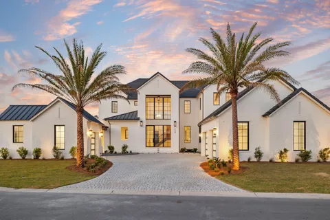 a front view of a house with a garden and patio