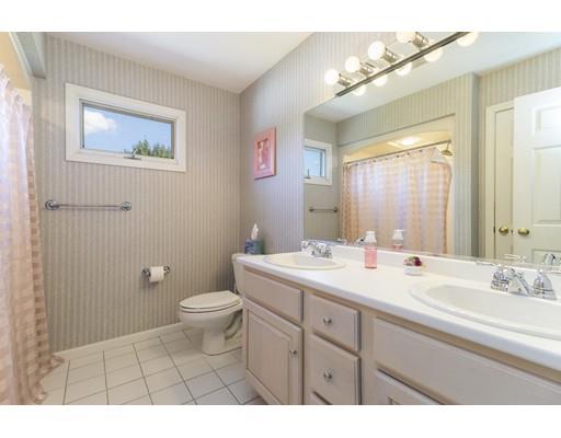 35 Culloden Drive Canton, MA 02021 - Photo 18 of 31 a bathroom with a toilet a sink a mirror and vanity