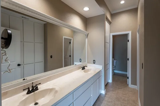 a spacious bathroom with a tub sink and mirror