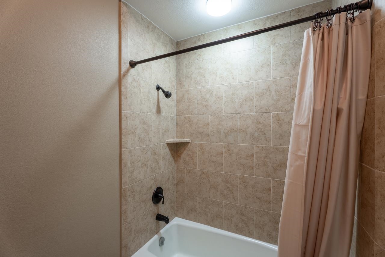 401 Hi There, Unit C Horseshoe Bay, TX 78657 - Photo 12 of 18 a bathroom with a shower and a tub