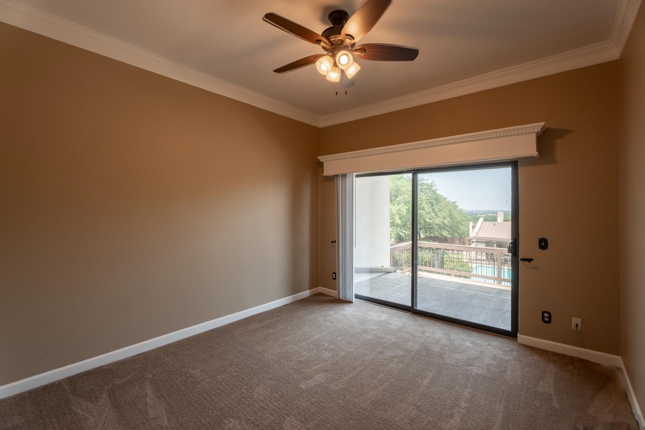 401 Hi There, Unit C Horseshoe Bay, TX 78657 - Photo 14 of 18 an empty room with windows and fan