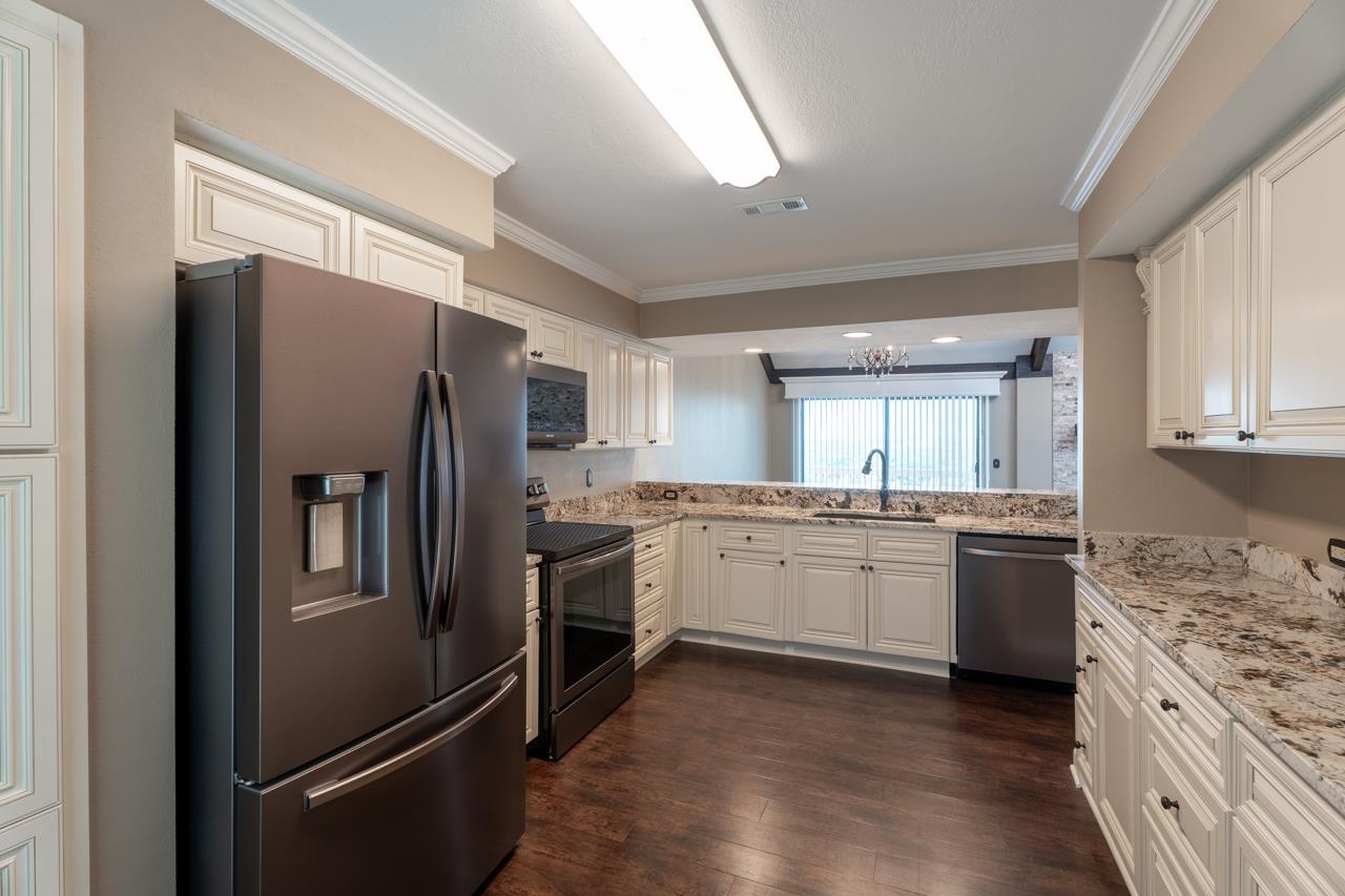 401 Hi There, Unit C Horseshoe Bay, TX 78657 - Photo 4 of 18 a kitchen with a refrigerator stove and sink