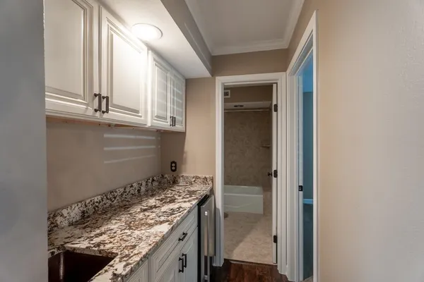 a kitchen with granite countertop a sink and a stove