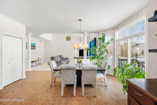 a view of a dining room with furniture window and outside view