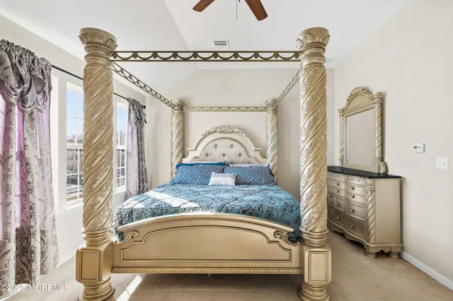 a living room with a bed and a flat screen tv