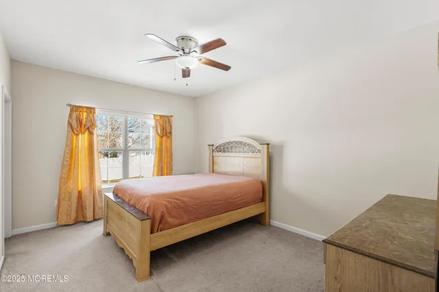 a bedroom with a bed rug and window