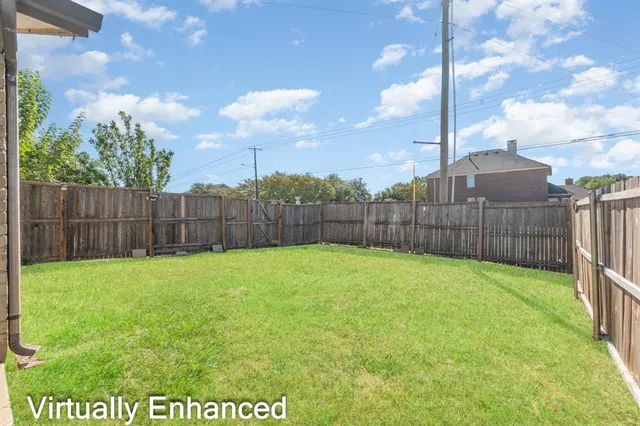 a view of a backyard with a tree