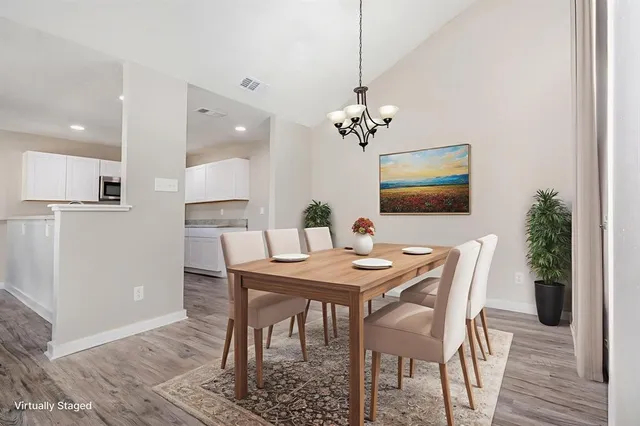 a view of a dining room with furniture and wooden floor