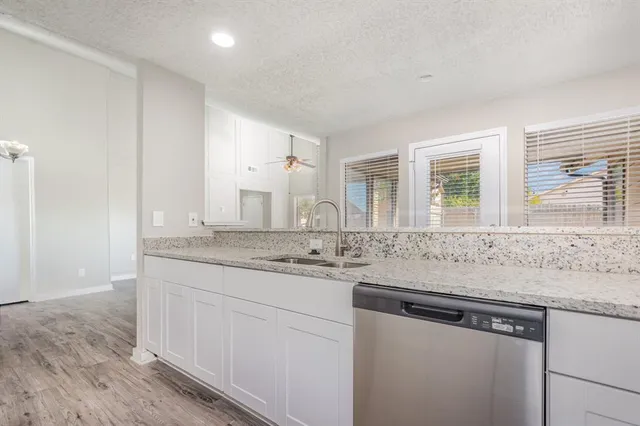 a kitchen with stainless steel appliances granite countertop a sink and a granite counter tops