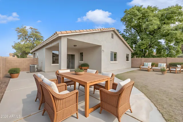 a view of a house with a backyard