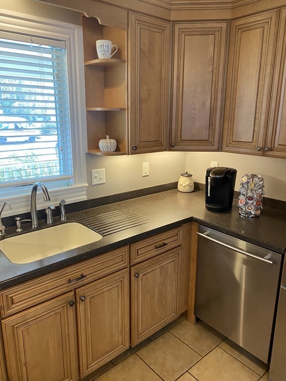 100 Union Point Road Webster, MA 01570 - Photo 8 of 31 a kitchen with granite countertop a sink stainless steel appliances and cabinets