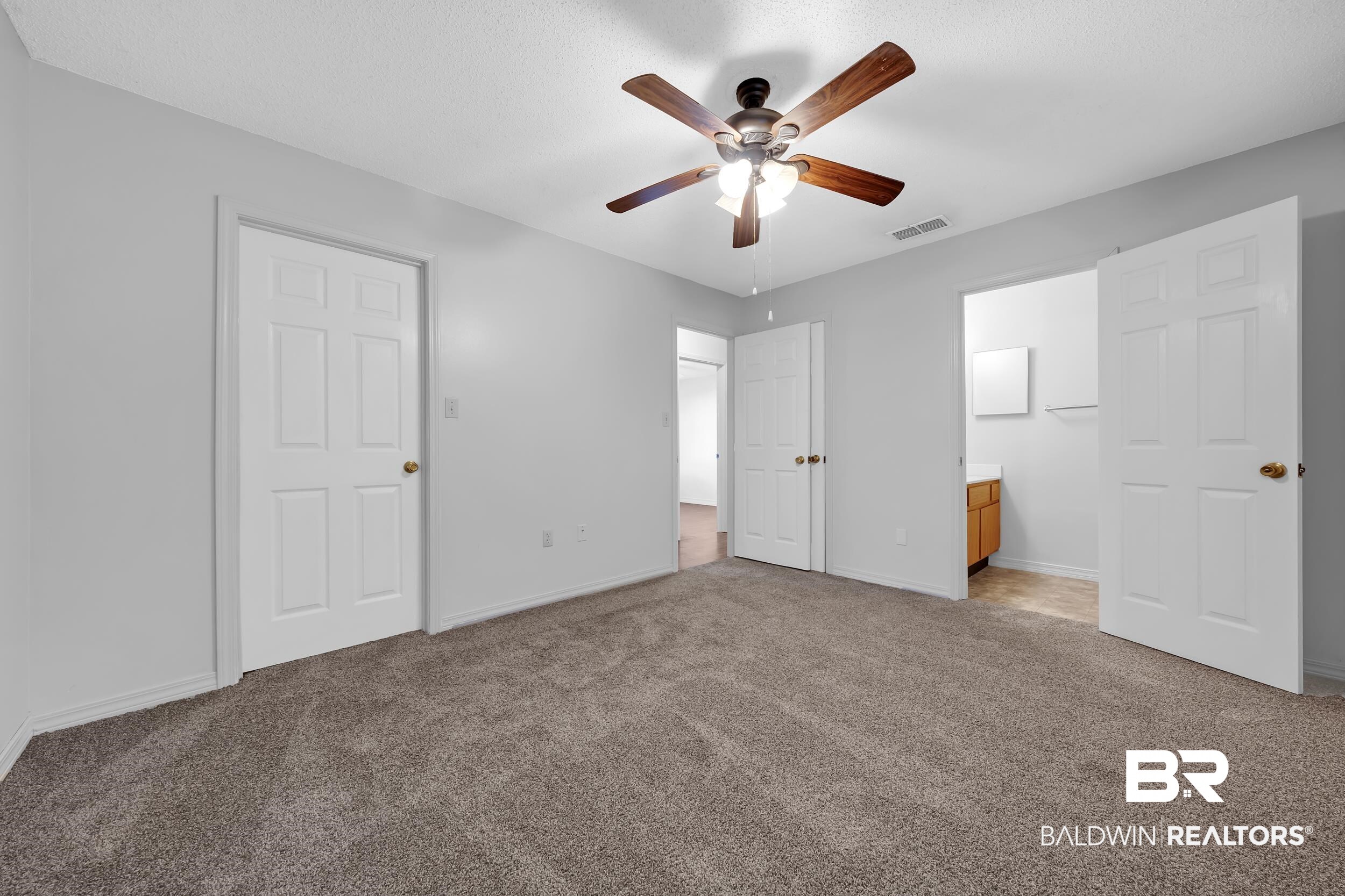 421 Cedar Court Foley, AL 36535 - Photo 30 of 39 Bedroom featuring a ceiling fan with light fixture, gray wall paint, and gray carpet flooring