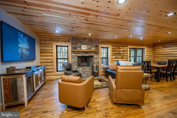 a living room with furniture a flat screen tv and a table