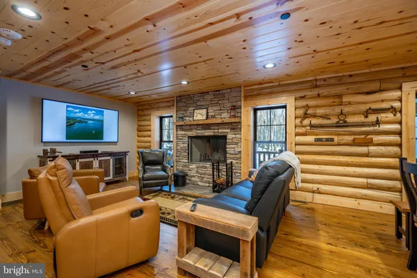 a kitchen with stainless steel appliances kitchen island granite countertop a table chairs sink and cabinets