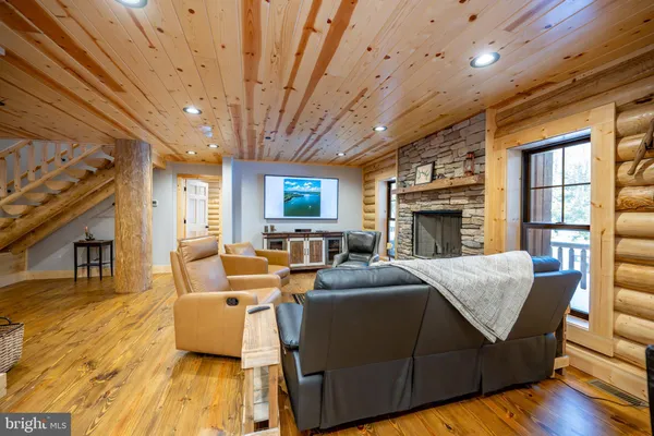 a kitchen with stainless steel appliances granite countertop a refrigerator a sink a stove a microwave and wooden cabinets