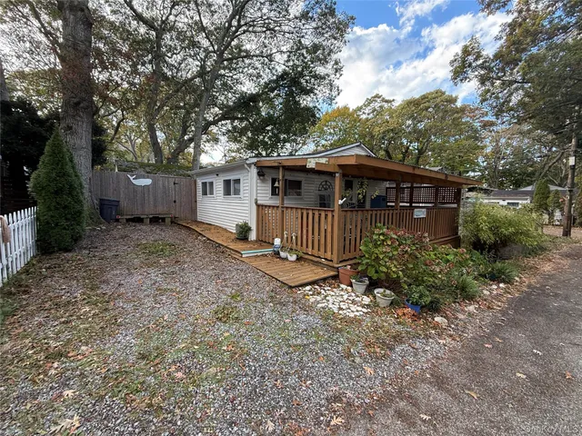 a view of a house with a yard and fence