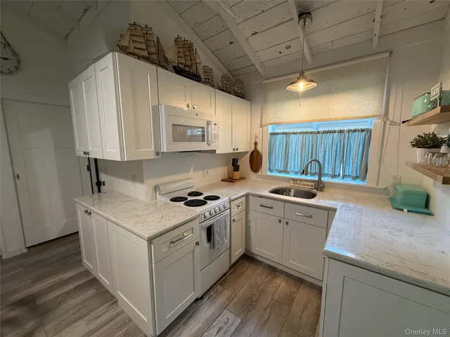 a kitchen with a stove top oven sink and cabinets
