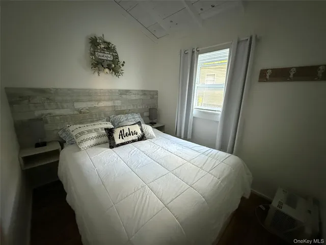 a bed sitting in a bedroom next to a window