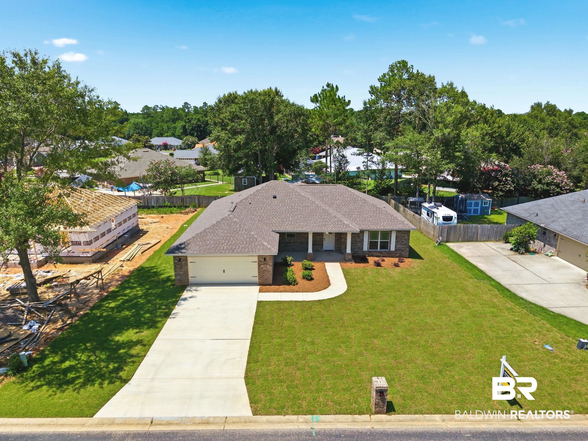 32656 Arbor Ridge Circle Lillian, AL 36549 - Photo 49 of 56 Single-story brick and siding residence featuring an attached two-car garage, concrete driveway, and a manicured front lawn