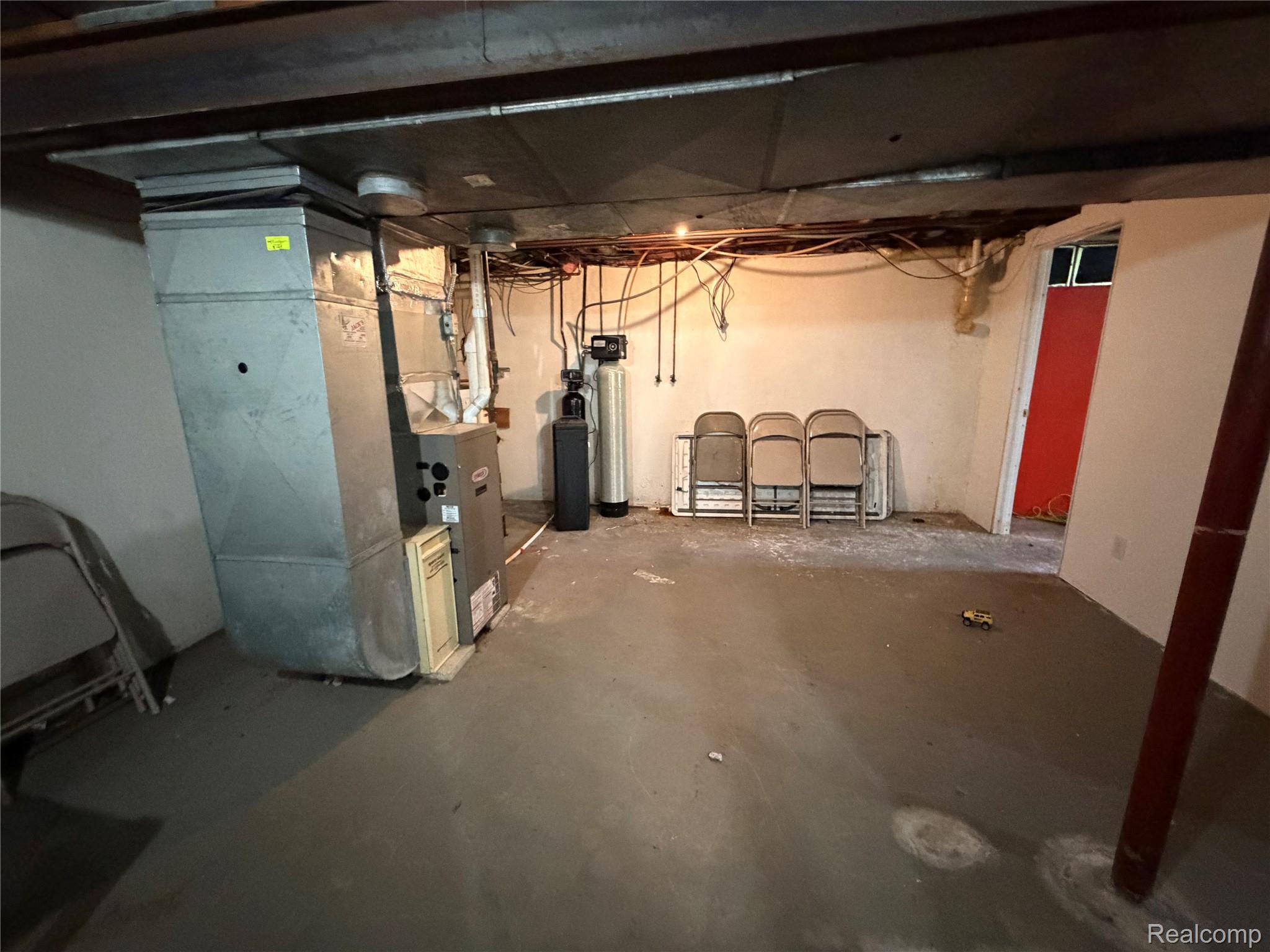 2712 North Branch Road North Branch, MI 48461 - Photo 35 of 37 Unfinished basement with heating unit and a water softener system