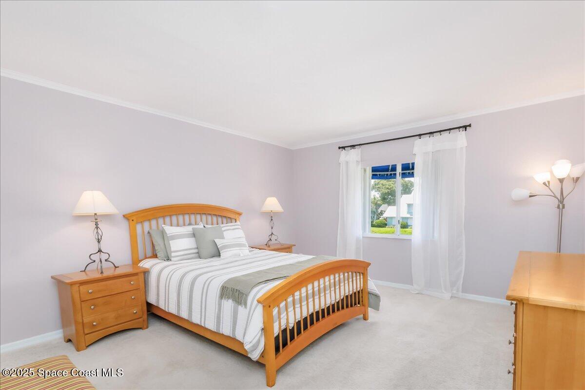 6124 River Run Drive Sebastian, FL 32958 - Photo 15 of 42 a bedroom with a bed a lamp and a window