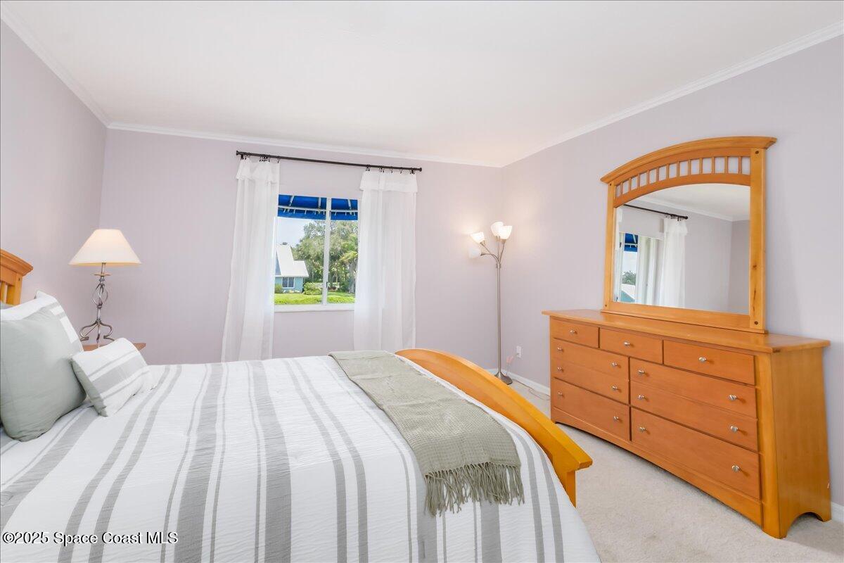 6124 River Run Drive Sebastian, FL 32958 - Photo 17 of 42 a bedroom with a bed and a mirror on dresser