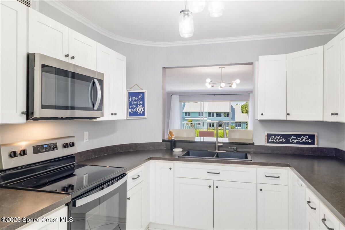 6124 River Run Drive Sebastian, FL 32958 - Photo 8 of 42 a kitchen with appliances a sink and cabinets