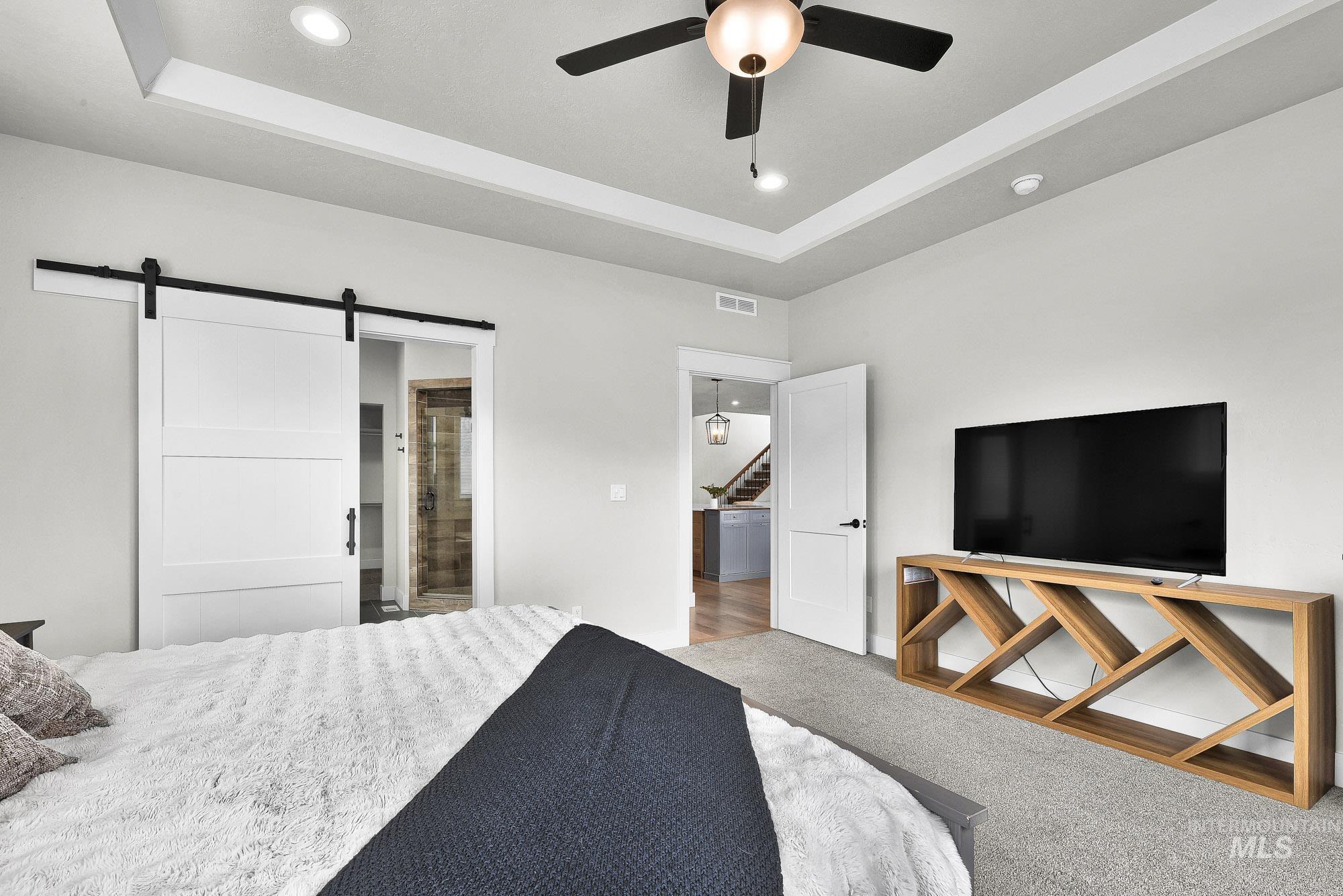 5676 East Zaffre Ridge Street Boise, ID 83716 - Photo 25 of 50 Spacious room featuring a tray ceiling, recessed lighting, and a ceiling fan
