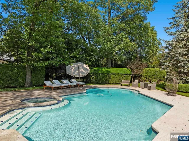 a view of a backyard with swimming pool