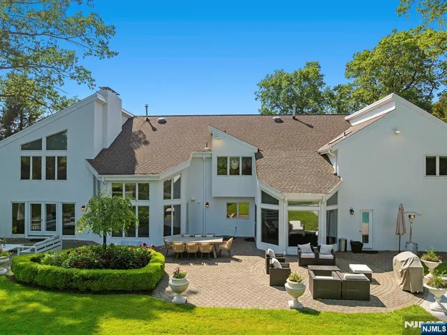a front view of a house with a garden and plants