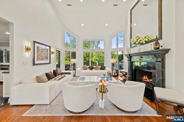 a living room with fireplace furniture and a large window