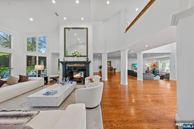 a living room with fireplace furniture and a wooden floor