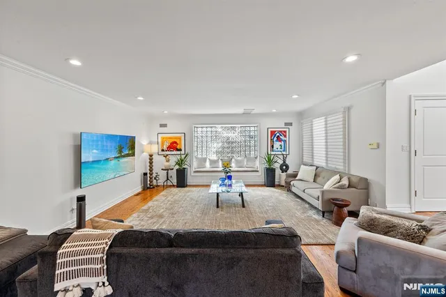 a living room with furniture a rug and a window
